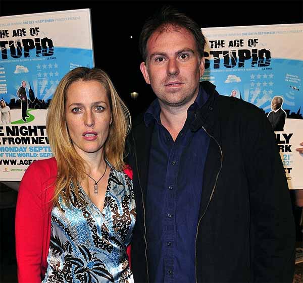 Julian Ozanne and Gillian Anderson posing for a photo.